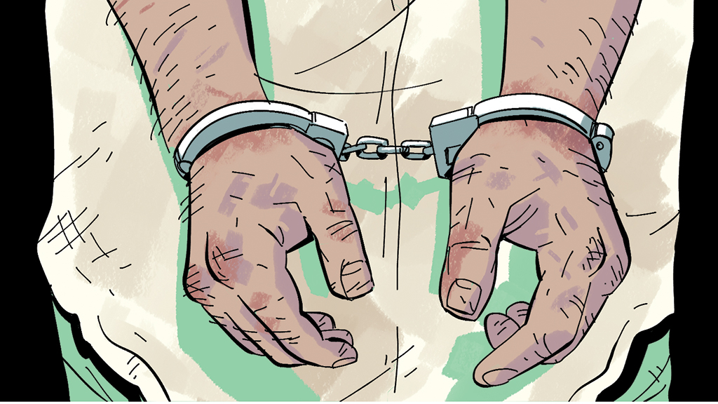 A pair of battered, handcuffed hands belonging to a Kuwaiti man.